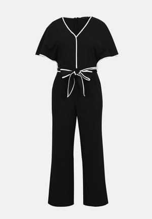 Črn širok kombinezon z belim robom, V-izrezom, kratkimi plaščastimi rokavi in pasom, ki se zaveže v vozlič.