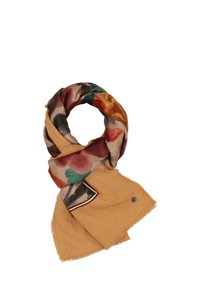 Yellow scarf featuring a floral-patterned silk overlay, with fringed edges and a small branded metal accent.