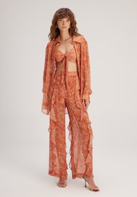 adL FLYWELL - Pantalones - Printed Orange