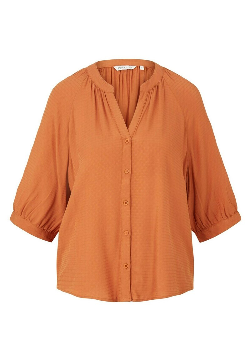 Rustfarbene Bluse mit V-Ausschnitt, Knopfleiste und kurzen Puffärmeln. Strukturierter Stoff mit einem dezenten Muster überall.