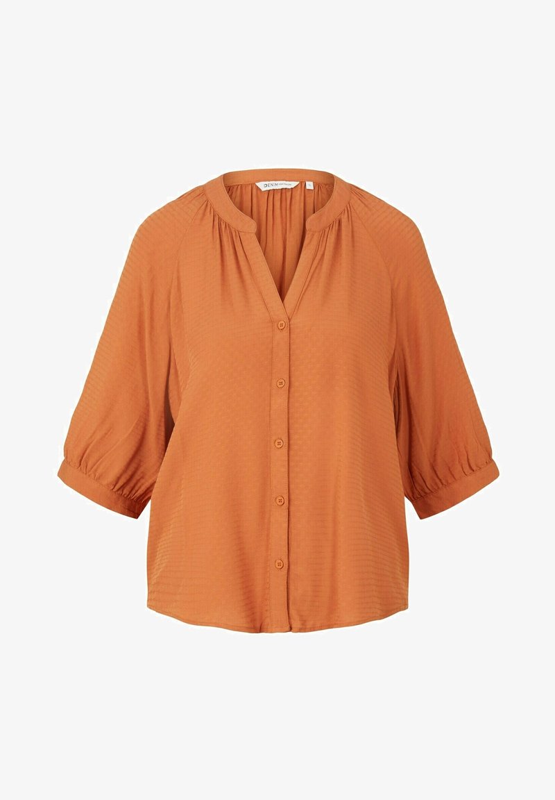 Rustfarbene Bluse mit V-Ausschnitt, Knopfleiste und kurzen Puffärmeln. Strukturierter Stoff mit einem dezenten Muster überall.