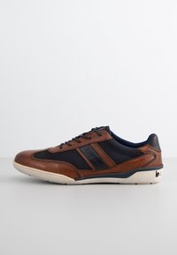 Brown leather and mesh sneaker with navy accents, rounded toe, contrasting cream sole, and a black logo detail on the side.
