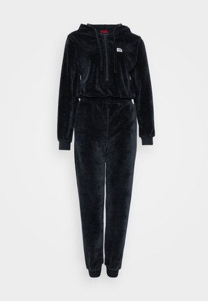 Black velour jumpsuit with a hood, long sleeves, and elastic waistband; features a front zip and ribbed cuffs. No patterns or accents.