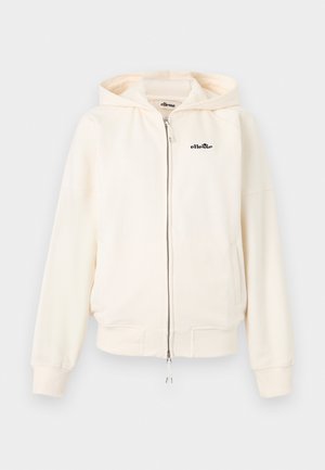 Sweat à capuche zippé couleur crème avec capuche, poignets et ourlet côtelés, poches avant, et petit logo noir "ellesse" sur la poitrine gauche.