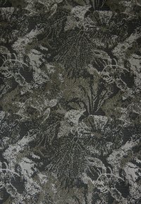 Textured fabric with a dark green and grey floral pattern, featuring intricate details and a soft, woven appearance.