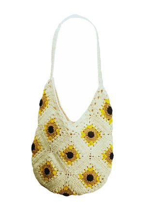 Sac à main crème au crochet avec des motifs de tournesol jaunes et bruns et une bandoulière unique.