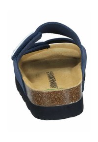 Navy blue sandal with a cork footbed, textured suede straps, and a metal buckle. The sole is black and slightly raised for comfort.