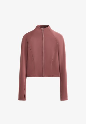 Veste courte en rose poussiéreux, tissu lisse, col montant, fermeture éclair à l'avant, manches longues avec poches latérales discrètes et détails de couture.