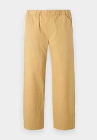 Khaki cargo pants with a loose fit, elastic waistband, button closure, and side pockets; made from lightweight cotton fabric.