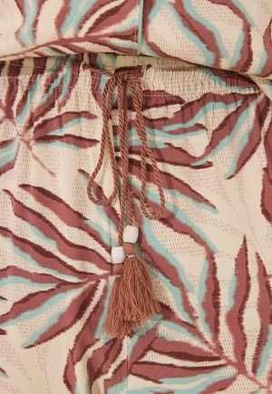 Kangaskudosta, jossa on ruskeita ja sinisiä lehtikuvioita, ominaisuuksina joustava vyötärö, sidottava naru koristehelmillä ja tupsuilla.