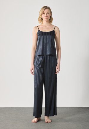 Navy satin pajama set with vertical stripes. Features a sleeveless top and loose, full-length pants with a smooth texture.