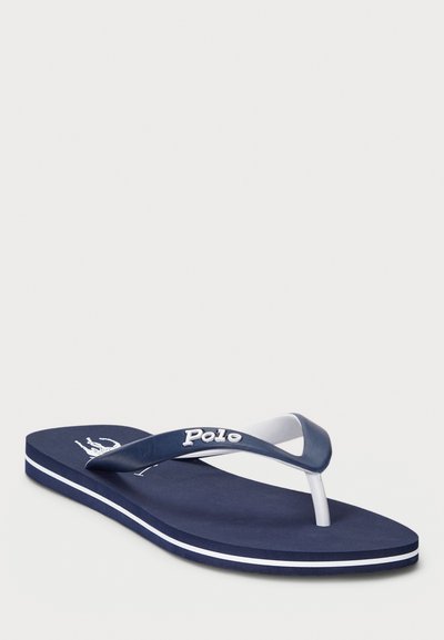 Navy flip-flop made of rubber with white accents. Features a textured footbed, contrasting white strap, and logo detail.
