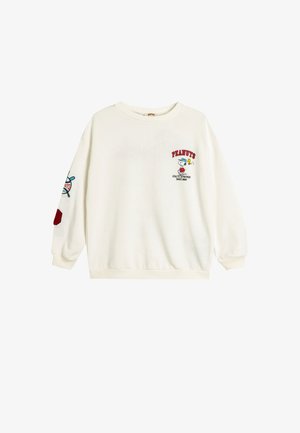 Cremefarvet pullover sweatshirt lavet af blødt stof, med "Peanuts" logo, Snoopy grafik og broderede detaljer i rød og blå på ærmerne.