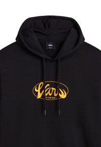 Musta huppari, jossa on naru. Korostaa keltaista brodeerattua "Vans" logoa ovaalissa muotoilussa, joka korostaa brändin designia. Pehmeä kankaan pinta.