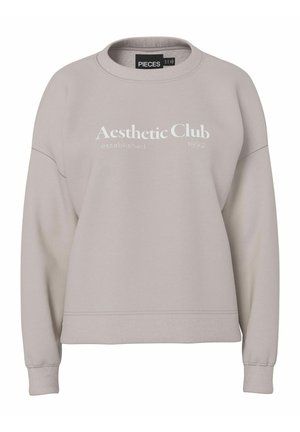 Jasnobeżowa bluza z długim rękawem, z okrągłym dekoltem, ściągaczami przy mankietach i na dole. Na przodzie biały nadruk z napisem "Aesthetic Club established 1892."