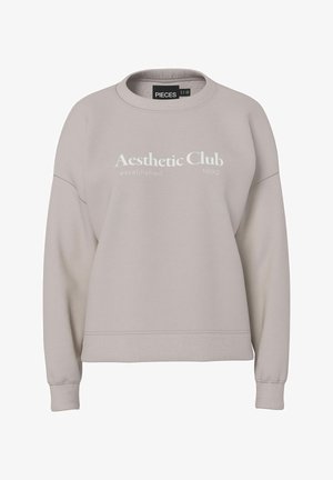 Sweat-shirt beige clair avec col rond, poignets et ourlet côtelés. Présente un texte imprimé blanc indiquant « Aesthetic Club established 1892 ».