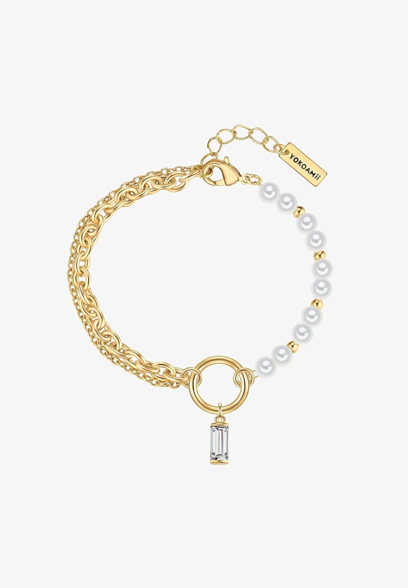 Auksinė grandinėlė su didelėmis nuorodomis ir mažomis perlamutrinėmis karoliukais, su centrinėmis žiedu ir skaidriu stačiakampiu žavesiu.