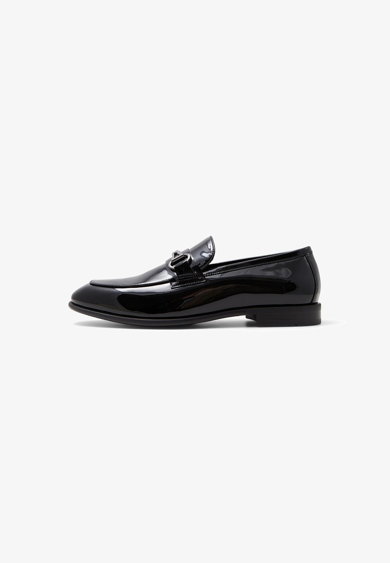 Black patent leather loafer with a rounded toe, sleek design, metal buckle accent, and a low-profile sole. Smooth, glossy finish.