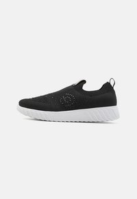 Fekete, slip-on stílusú sneaker légáteresztő kötött anyagból, texturált felső résszel, fehér gumitalppal és megerősített saroktabbal.