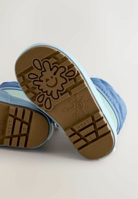 Blue rubber-soled shoes with a textured brown outsole featuring a smiley face and water droplets. Lightweight design with soft upper material.