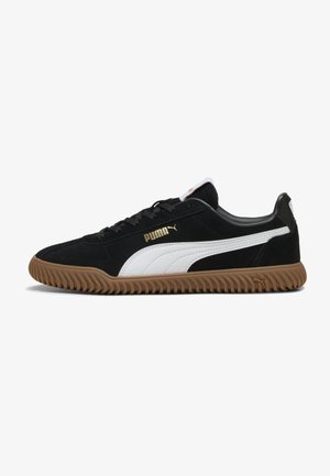 Black suede sneakers with white accents, textured rubber sole, and gold logo detail. Features lace-up front and cushioned collar for comfort.