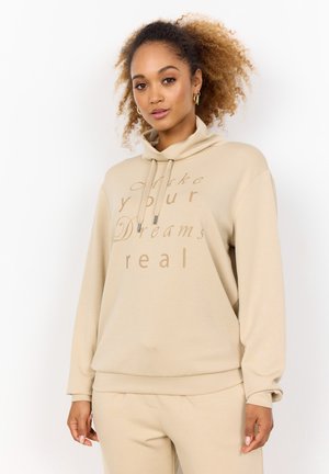 Beige sweatshirt with a high neck and drawstrings. Features text in darker beige: "Make your Dreams real." Soft, smooth fabric, relaxed fit.