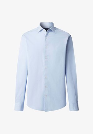 Vaaleansininen, pitkähihainen, nappikauluksinen puuvillapaita, jossa on klassinen kaulus, hienovarainen rintalogo ja yksivärinen kangas.