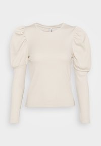 Haut à manches longues en tissu côtelé blanc cassé. Caractéristiques : épaules bouffantes et coupe ajustée. Encolure arrondie avec des détails de couture subtils.