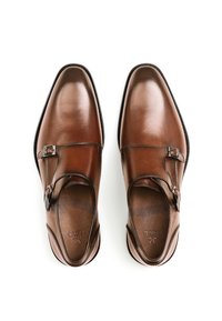 Brown leather dress shoes with a smooth finish, rounded toe, and a side buckle accent. Features a low heel and flexible sole.
