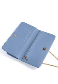 Portafoglio in pelle blu con finitura texture, dotato di slot per carte, tasca con zip, accessori in oro e tracolla. Chiuso con un bottone a scatto.