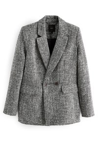 Blazer texturizzato in bianco e nero con colletto a revers, bottoni doppi e due tasche frontali. Interno foderato.