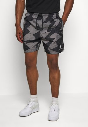 Czarno-szare kąpielówki w wzór z elastycznym paskiem do regulacji, z zygzakowymi kształtami i akcentem logo na dolnym brzegu.