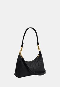 Sac à bandoulière en cuir noir avec des accessoires dorés, fermeture zippée et bandoulière détachable sur un fond clair uni.