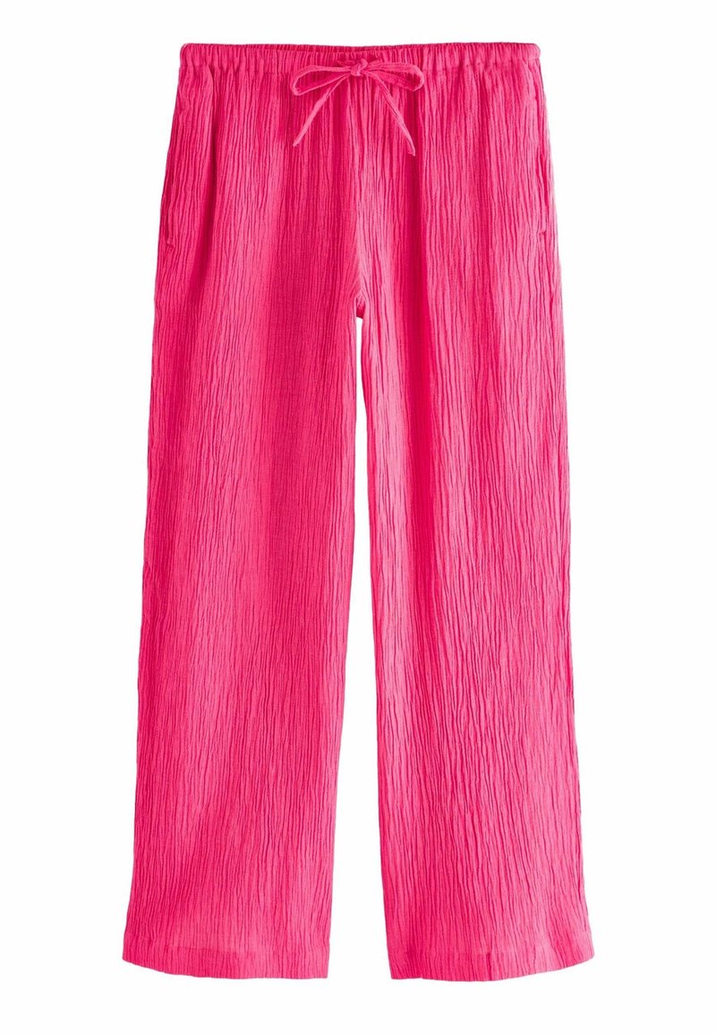 Pantalon large rose vif texturé avec une ceinture élastique et un cordon noué à l'avant.