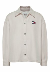 Light beige herringbone jacket with a collar and front button closure. Features a Tommy Jeans logo patch on the left side. Textured fabric.