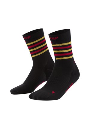 Schwarze Sportsocken mit roten und goldenen horizontalen Streifen. Verfügt über verstärkten Zehen- und Fersenbereich, elastischen Bund und Markenlogo in Pink.