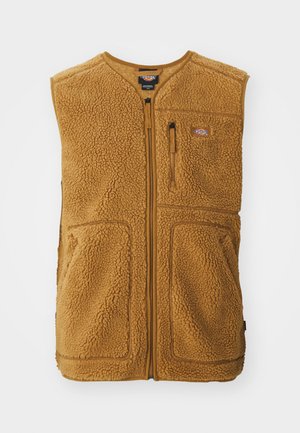 Brun sherpa fleece vest med frontglidelås, tre lommer og et lite logo-patch på øvre venstre bryst.