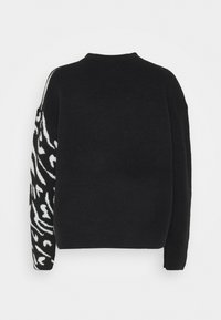 Schwarzer Pullover mit einem schwarz-weißen gemusterten linken Ärmel. Besitzt einen runden Halsausschnitt und eine lockere Passform, gefertigt aus weichem Strickmaterial.