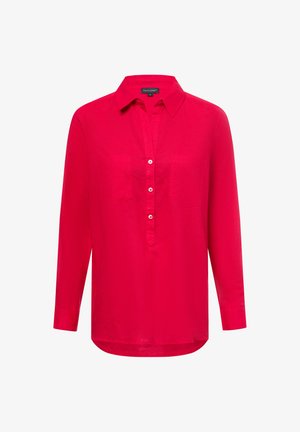 Langärmliges, leuchtend pinkes Shirt mit kragenlosem Ausschnitt, vorderem Knopfverschluss, zwei Brusttaschen und abgerundetem Saum. Glatte Textur.