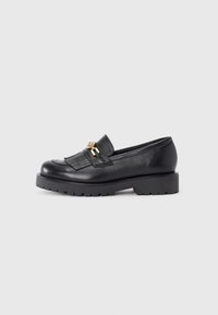 Black leather loafers with a textured finish, featuring a gold-tone hardware accent and a chunky black platform sole.