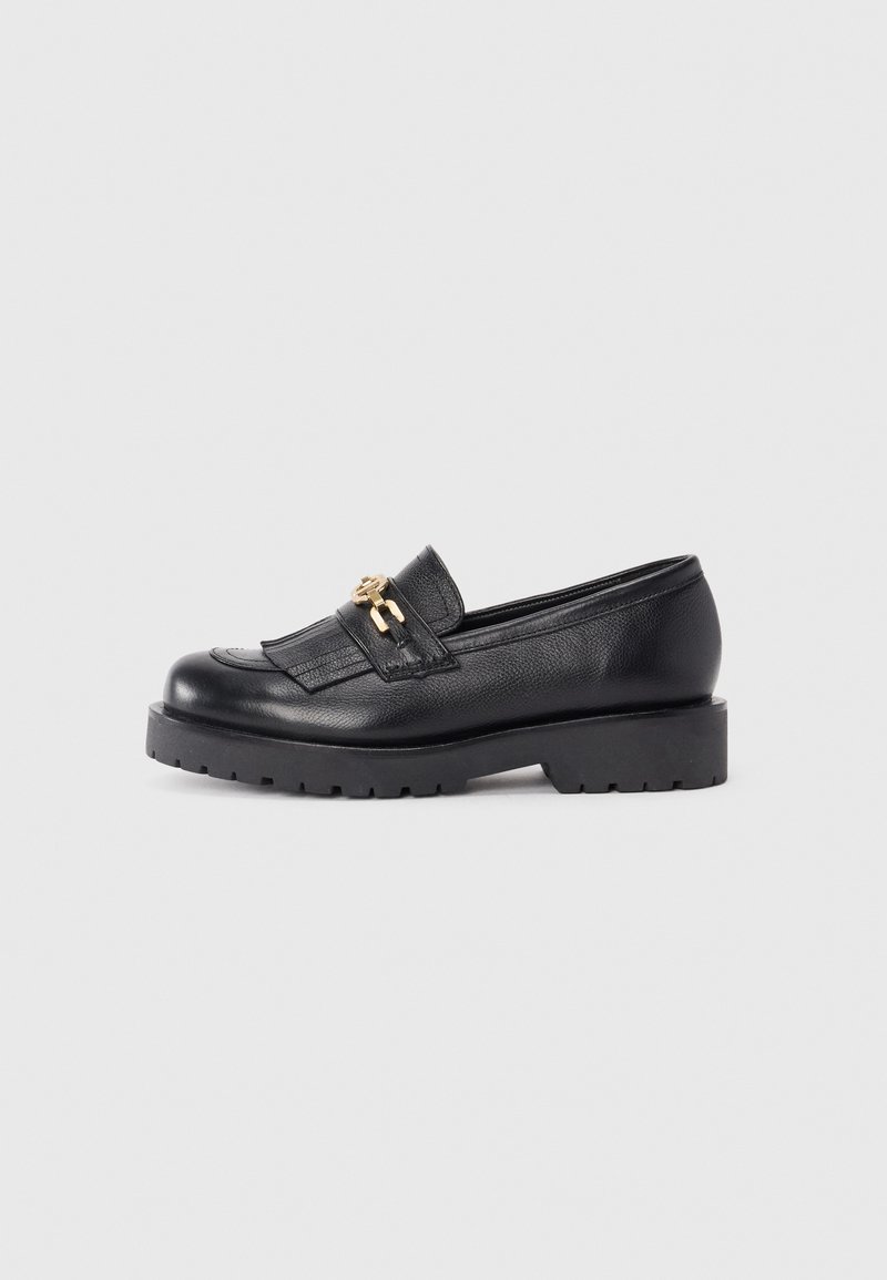 Black leather loafers with a textured finish, featuring a gold-tone hardware accent and a chunky black platform sole.