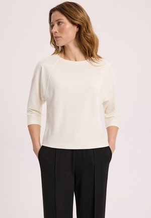 - Bluzka z długim rękawem