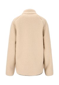 Beige fleecejakke med høj krave, raglanærmer og en blød, tekstureret overflade. Har en rundet kant og ingen synlig hardware.