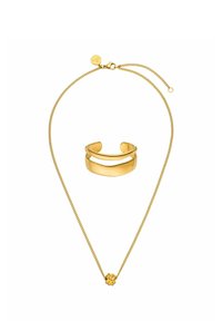 Goldkette mit feiner Kette und einem dekorativen Knotenanhänger, begleitet von einem passenden goldenen Armreif mit geschwungenem Design.