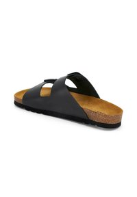 Sandale glissante en cuir noir avec une semelle en liège, dotée de détails en design découpé et d'une semelle en caoutchouc pour une bonne adhérence.