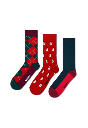 Drei Paar Socken: eines mit grün-rotem Argyle-Muster, eines mit roten Schneemännern und eines in einfarbigem Dunkelblau mit einer pinken Spitze. Alle haben das "HAPPY"-Logo.