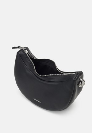 Black crescent-shaped leather handbag with silver zipper partially open and silver chain strap attachment.