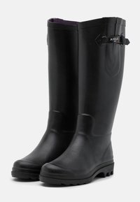 Black rubber knee-high boots with a smooth texture, round toe, and a sturdy treaded sole. Features a side buckle and contrasting purple lining.