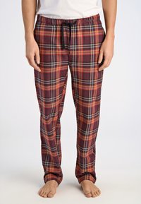 Röda och grå rutiga pyjamasbyxor i mjukt tyg, med elastisk midja och svart snörning samt ribbade muddar.