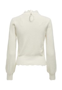 White sweater with long sleeves, textured fabric, scalloped hem, and a keyhole detail at the back, featuring a ruffled collar.